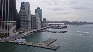 AX84_115 - 4K aerial stock footage Flying by Downtown Manhattan Heliport, tilt down, New York, New York