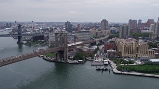 AX84_116E - 4K aerial stock footage approach Brooklyn Bridge, pan to Brooklyn buildings, New York City