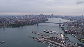 AX84_121E - 4K aerial stock footage of the Williamsburg Bridge and Midtown Manhattan skyline, New York City