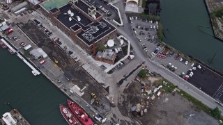 AX84_123 - 4K aerial stock footage Flying over Brooklyn Navy Yard piers, reveal Williamsburg Bridge, New York, New York
