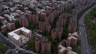 AX84_127E - Aerial stock footage of 4K aerial Video fly over public housing on the Lower East Side housing, tilt to reveal Midtown skyline, New York City
