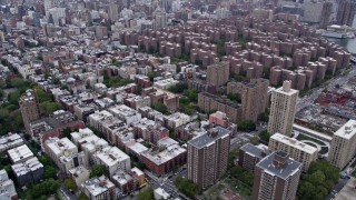 AX84_129E - 4K aerial stock footage fly over East Village apartment buildings, tilt to reveal Stuyvesant Town and Midtown skyline, New York City