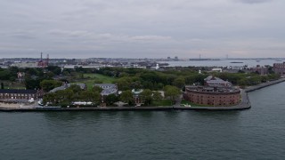 AX84_161 - Aerial stock footage of 4K Aerial Video Flying by Castle Williams, Governors Island, New York Harbor, New York, New York