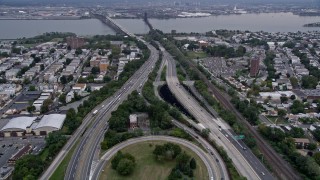 AX84_169E - 4K aerial stock footage of flying over New Jersey Turnpike, Jersey City, New Jersey