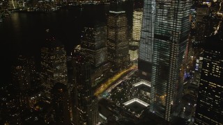 AX85_015 - 4K aerial stock footage Tilting down on World Trade Center Memorial, New York, New York, night