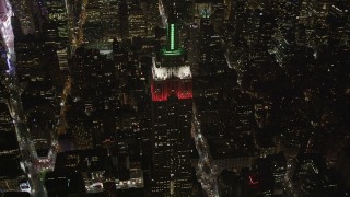 AX85_037 - 4K aerial stock footage Tilt down on Empire State Building, Midtown Manhattan, New York, New York, night