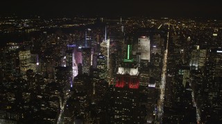 AX85_058 - 4K aerial stock footage Flying by Empire State Building, Midtown Manhattan, New York, New York, night