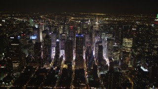 AX85_093 - 4K aerial stock footage Skyscrapers in Midtown Manhattan, streets, New York, New York, night