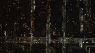 AX85_098 - 4K stock footage aerial video Bird's eye view over city streets, Midtown Manhattan, New York, New York, night