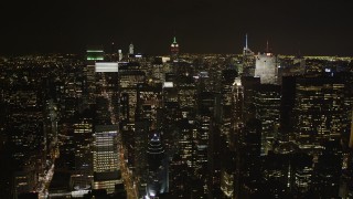 AX85_104 - 4K aerial stock footage Flying by Midtown Manhattan skyscrapers, New York, New York, night