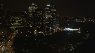 AX85_124 - 4K aerial stock footage Flying by Lower Manhattan skyscrapers, Battery Park, New York, New York, night