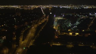 AX85_139 - 4K aerial stock footage Flying over New Jersey Turnpike, Newark Bay Bridge, Newark, New Jersey, night