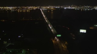 AX85_140 - 4K aerial stock footage Flying over Newark Bay Bridge, Newark, New Jersey, night