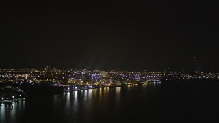AX85_142 - 4K aerial stock footage Flying by an oil refinery on the shore, Newark Bay, Newark, New Jersey, night