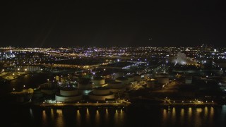 AX85_144 - 4K aerial stock footage Flying by an oil refinery, Newark Bay, Newark, New Jersey, night