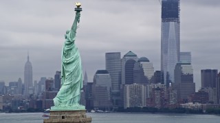 AX86_002 - 4K aerial stock footage fly around the Statue of Liberty with Lower Manhattan in the background, New York City