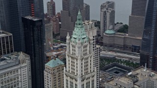 AX86_007 - 4K aerial stock footage of flying past the top of the Woolworth Building in Lower Manhattan, New York City