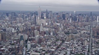 AX86_027 - 4K aerial stock footage tilt from Lower East Side to reveal the Empire State Building and Midtown Manhattan, New York City