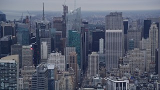 AX86_030 - 4K aerial stock footage passing Midtown skyscrapers, reveal Chrysler Building, Empire State Building, New York City