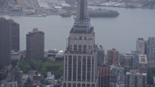 AX86_033 - 4K aerial stock footage of the Empire State Building's observation decks in Midtown Manhattan, New York City