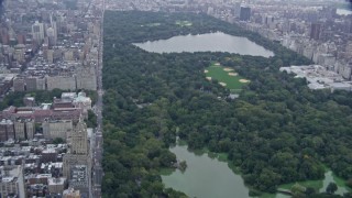 AX86_052 - 4K aerial stock footage tilt from Central Park West to reveal Central Park, New York City