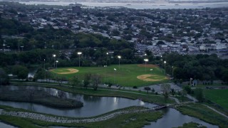 AX86_086 - 4K aerial stock footage of flying by baseball fields in Jersey City, New Jersey