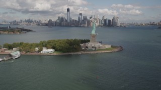 AX87_001 - 4K aerial stock footage Reveal Statue of Liberty, Liberty Island, Lower Manhattan, New York