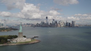 AX87_002 - 4K aerial stock footage Statue of Liberty, Liberty Island, Lower Manhattan skyline, New York, New York