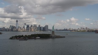 AX87_005 - 4K aerial stock footage Approach Statue of Liberty, Lower Manhattan skyline, New York, New York