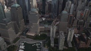 AX87_032 - 4K aerial stock footage Flying by the World Trade Center Memorial, Lower Manhattan, New York, New York