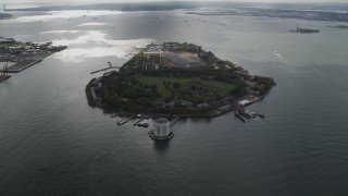 AX87_040 - 4K aerial stock footage Approaching Governors Island, New York Bay, New York, New York