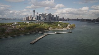 AX87_043 - 4K aerial stock footage Flying by Lower Manhattan skyline, from Governors Island, New York, New York