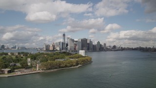 AX87_044 - 4K aerial stock footage Flying by Lower Manhattan skyline, from  Governors Island, New York, New York