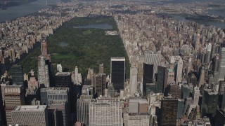 AX87_079 - 4K stock footage aerial video Tilt up from Midtown skyscrapers, revealing Central Park, New York, New York