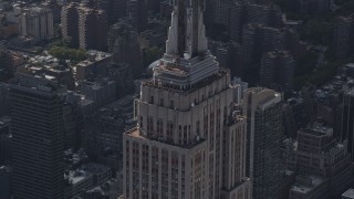 AX87_108 - 4K aerial stock footage Flying by top decks of Empire State Building, Midtown Manhattan, New York