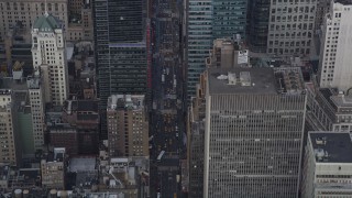 AX87_115 - 4K aerial stock footage Tilt up from 7th Avenue, revealing Times Square, Midtown Manhattan, New York