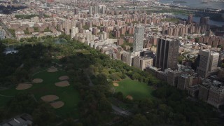 AX87_123 - 4K stock footage aerial video Panning across Upper East Side buildings, Central Park, New York, New York