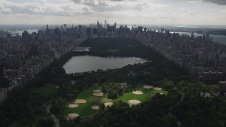 AX87_131 - 4K stock footage aerial video Flying by Central Park, seen from Harlem, New York, New York