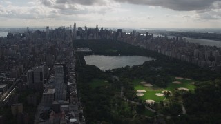 AX87_132 - 4K aerial stock footage Flying by Central Park, Upper East Side, seen from Harlem, New York, New York