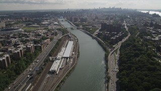 AX87_175 - 4K stock footage aerial video Tilt from Harlem River, Washington Heights, reveal Harlem, New York, New York
