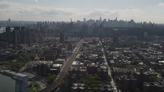 AX87_180 - 4K aerial stock footage Flying by the Midtown Manhattan skyline, seen from Harlem, New York, New York