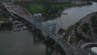AX87_182 - 4K stock footage aerial video Tilting down on Robert F. Kennedy Bridge, Harlem, New York, New York