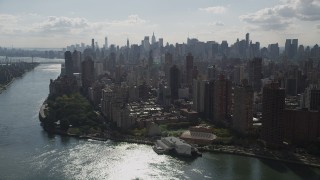 AX87_185 - 4K aerial stock footage Fly by Midtown Manhattan skyline, from Upper East Side, New York, New York