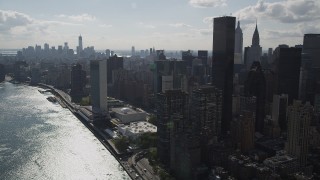 AX87_190 - 4K aerial stock footage of flying by United Nations, Midtown Manhattan, East River, New York, New York