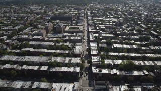 AX88_019 - 4K aerial stock footage of following a street past row houses near 8th Avenue Armory, Brooklyn, New York
