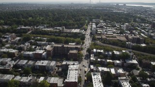 AX88_021 - 4K aerial stock footage of flying over row houses, approaching Green-Wood Cemetery, Brooklyn, New York