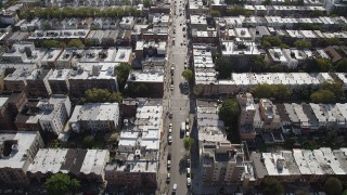 AX88_025 - 4K stock footage aerial video of following 8th Avenue past row houses, Brooklyn, New York