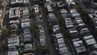 AX88_038 - 4K stock footage aerial video of following railroad tracks through urban neighborhood in Brooklyn, New York
