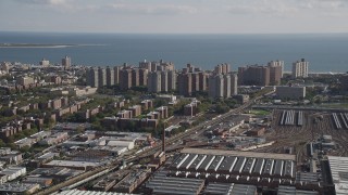 AX88_041 - 4K aerial stock footage of approaching apartments on coast, Coney Island, Brooklyn, New York