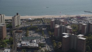 AX88_042 - 4K aerial stock footage flyby apartment buildings toward the beach, Luna Park in Coney Island, Brooklyn, New York